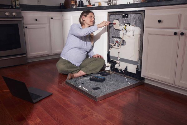 Woman repairs a dishwasher