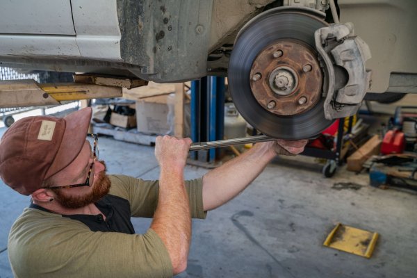 man working on car brakes